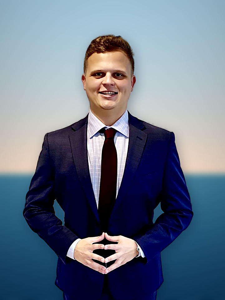 Cole Thomas, founder of Coastline Web Co., in a navy suit